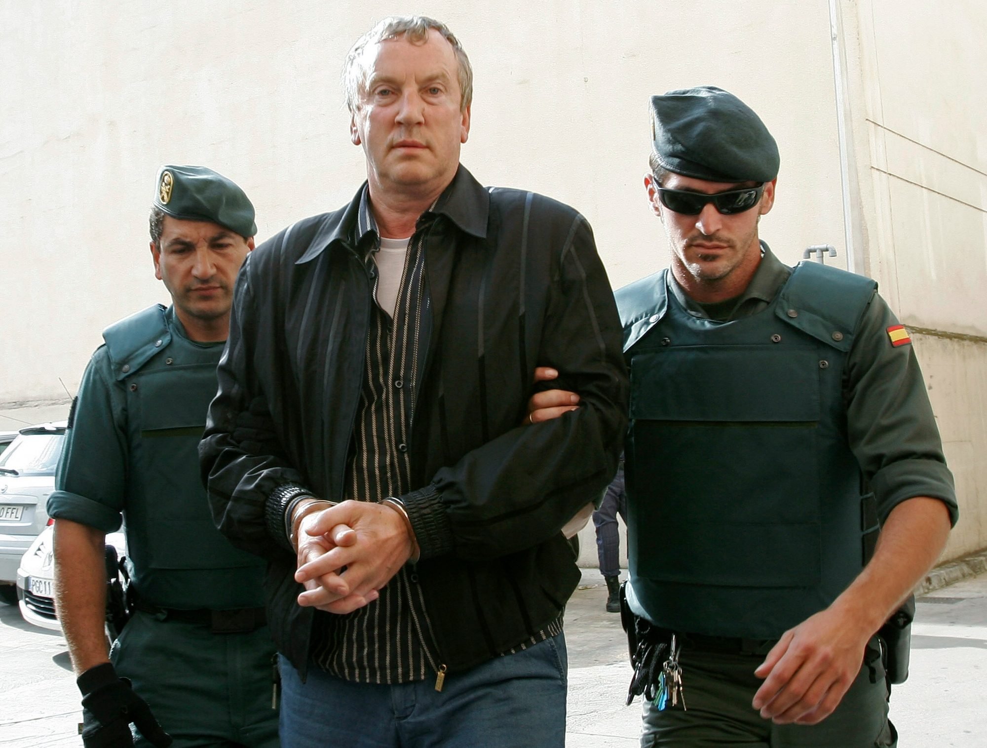 Police officers accompany Gennady Petrov, a mob boss linked to top Russian officials, after his arrest on the island of Mallorca in 2008. Photo credit: Dani Cardona/Reuters Police officers accompany Gennady Petrov, a mob boss linked to top Russian officials, after his arrest on the island of Mallorca in 2008. Photo credit: Dani Cardona/Reuters